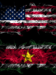United States of America, America, US, USA, American vs Suriname smoky mystic flags placed side by side. Thick colored silky abstract smoke flags