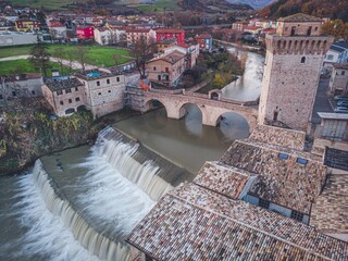 Italian village roman bridge with waterfall, river - long exposure