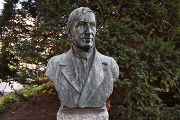 Lodi, Italy Alessandro Volta marble bust located in the main city garden on a green background