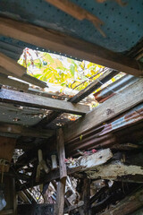 Fototapeta na wymiar Abandoned house with a fallen roof