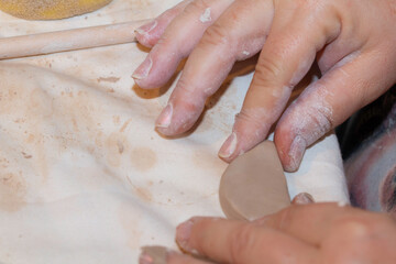 A ceramist is trying to shape her work.  Home hobby in quarantine.