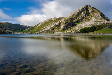 landscape of the lake with crystal clear and transparent water. you can see the stones at the bottom of the water.