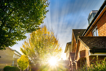 Traditional English brick house with sun flare