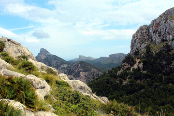 Colorful mountain landscape with beautiful rocks and soft clouds in the highlands of Majorca island, Spain.