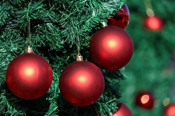 Christmas background red balls on green branches of an artificia