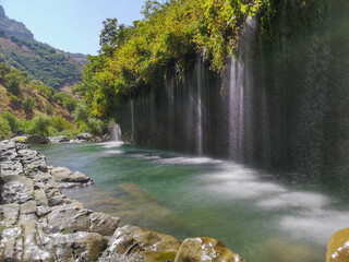 waterfall flowing in nature, cascade, cascade between rocks. Hakkari in Turkey
