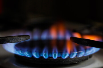 Shallow depth of field (selective focus) image with a burning old traditional gas stove top.