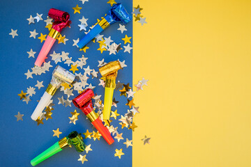 Birthday party whistles on color background.Colorful celebration pattern with party blower horns....