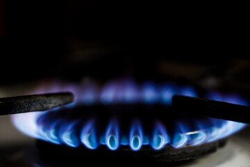 Shallow depth of field (selective focus) image with a burning old traditional gas stove top.