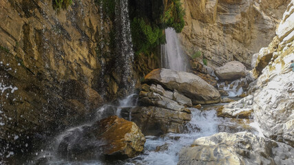 waterfall flowing in nature, cascade, cascade between rocks. Hakkari in Turkey
