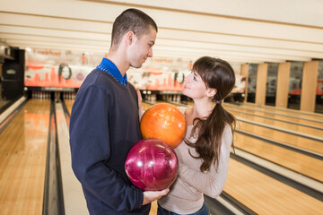 Fototapeta premium a beautiful young couple playing bowling in a bowling club