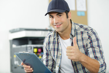 hardware repairman repairing broken printer fax machine