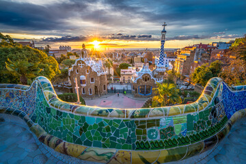 Beautiful sunrise in Barcelona seen from Park Guell. Park was built from 1900 to 1914 and was...