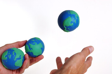 Juggling three worlds on a white background
