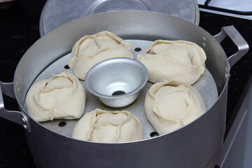 Delicious Manty, posture, khinkali is prepared in a special pot - mantoverde. dishes of Asian, Buryat, and Georgian cuisine. Cooking homemade manta rays