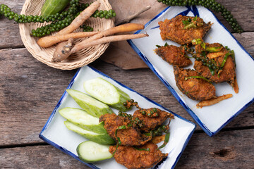 Stir fried catfish curry paste on wooden background.copy space