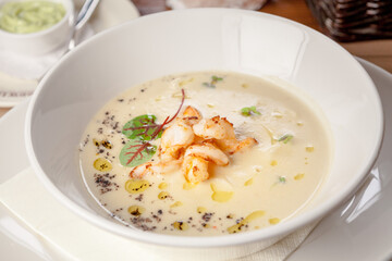 White vegetable soup with tiger-prawns