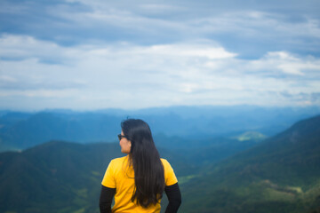 rear of happy woman wear white dress on top mountain looking view with mist and cloud at morning light Soft focus.