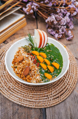 Breakfast Detox Green Smoothie bowls  from Green tea and Spinach with fruits, nuts, seeds and homemade granola and strawberry for healthy vegan vegetarian.