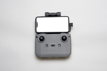 Remote control quadrocopter with a mobile phone with a white screen. Remote control on a white background.