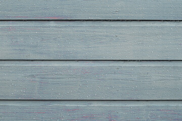 Colored wood fencing background with rain water droplets, wet, horizontal.