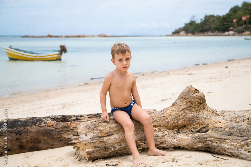 Wall mural happy boy on the beach