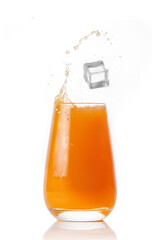 Glass of fruit juice with ice on a white background.