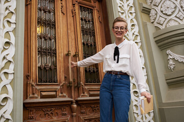 pretty woman near the door on the street exterior museums columns education institute