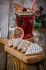 christmas still life with gingerbread cookies and mulled wine on wooden background