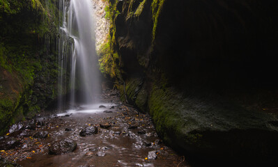Fototapeta na wymiar waterfall with polished green walls
