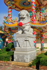 Lion Statue in a Chinese temple during a sunny day .