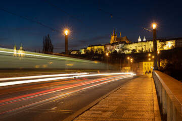 Scenic view of illuminated Prague skyline seen from Mánes bridge. Traffic light trails in the twilight