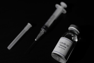 covid 19 corona virus cure treatment vaccine with syringe black background
