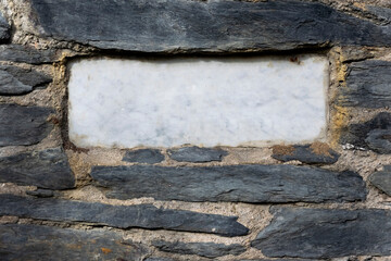 Marble plaque on a slate wall without inscription