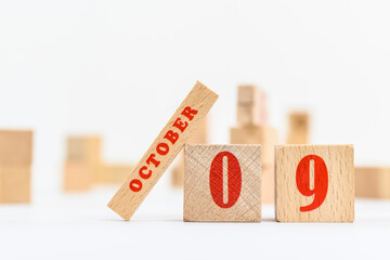9th of October on the wooden calendar blocks on white background.