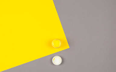 A can of yellow paint on a yellow-gray background.Trending colors 2021