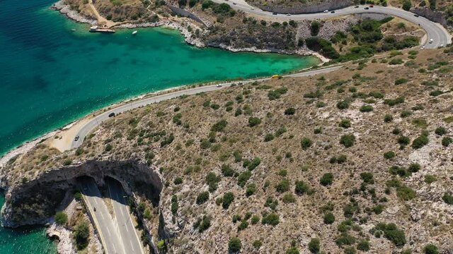Aerial drone video of Tunnel in Athens riviera seaside road known as hole of Karamanlis or "Tripa of Karamanlis", Attica, Greece