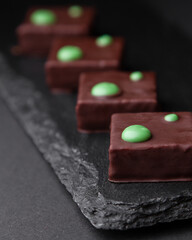 sliced square chocolates on black board