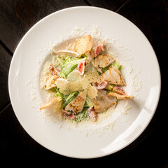 Caesar salad with chicken parmesan and croutons