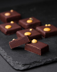 sliced square chocolates on black board