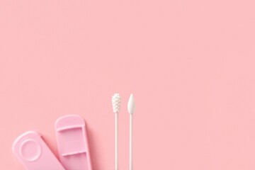 Reusable silicone swab on pink background. Alternative to cotton buds flat lay top view