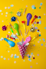 Yellow party background with party hat and ballons, candles