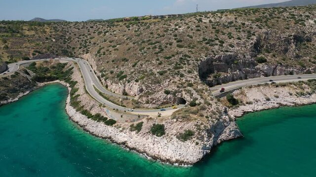 Aerial drone video of Tunnel in Athens riviera seaside road known as hole of Karamanlis or "Tripa of Karamanlis", Attica, Greece