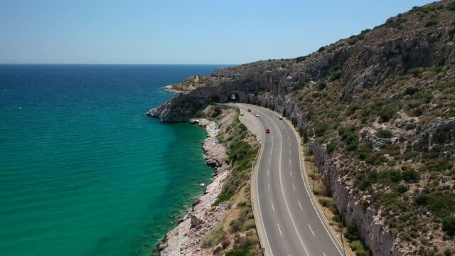 Aerial drone video of Tunnel in Athens riviera seaside road known as hole of Karamanlis or "Tripa of Karamanlis", Attica, Greece