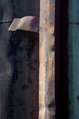 Rusty metal rain gutter on wall