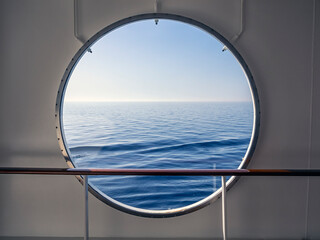 View through porthole with Blue Sea and view to horizon 