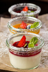 assorted panna cotta with jam decorated with fruit