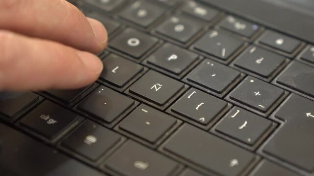 keyboard with letter ñ. Close up hand typing on keyboard with letter ñ