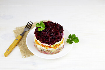 Plate with russian traditional new year salad herring under fur coat (shuba).