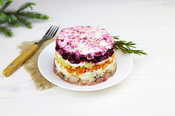 Plate with russian traditional new year salad herring under fur coat (shuba).